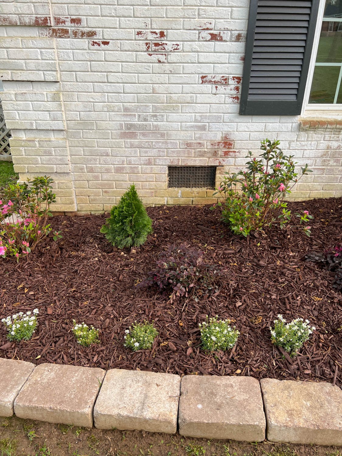 dirt and grass stains on white brick