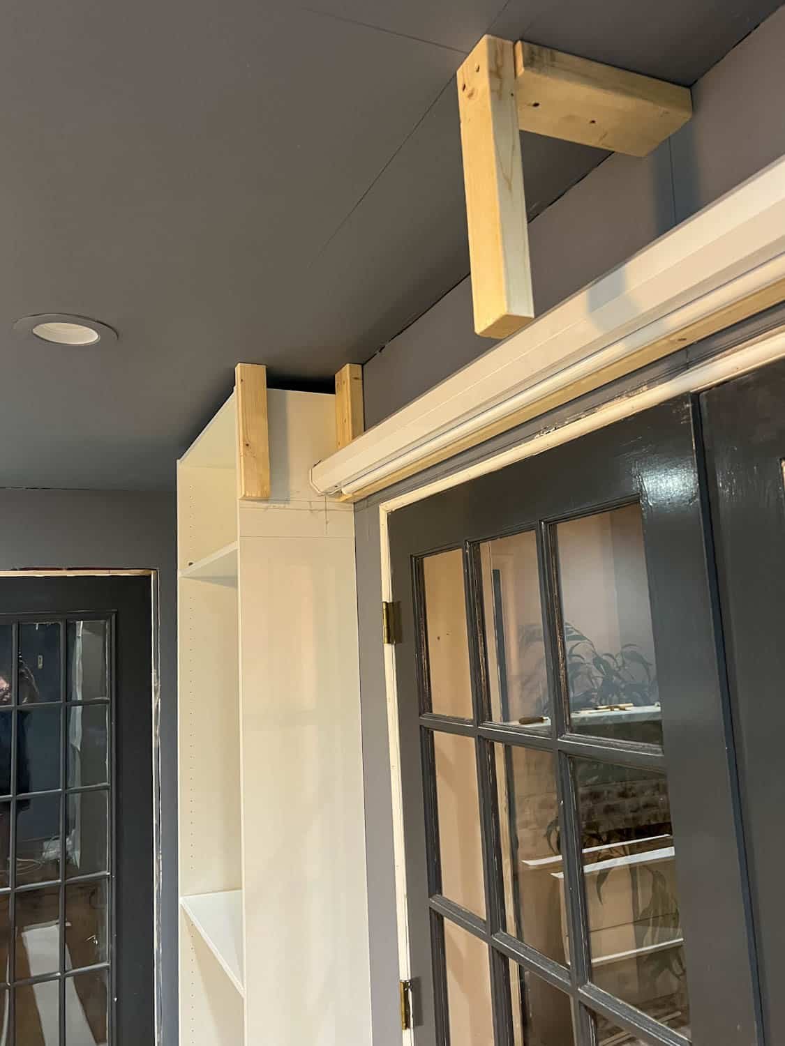 anchoring 2x4s between bookcases
