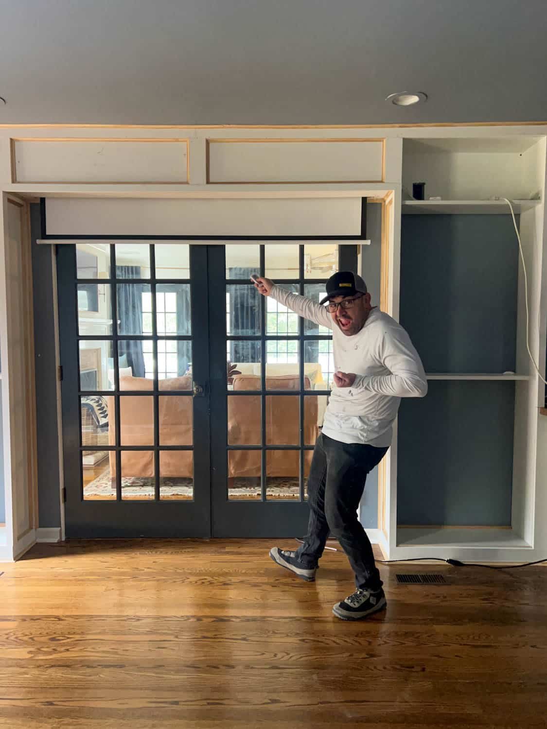 retractable projector screen with remote hidden above French doors