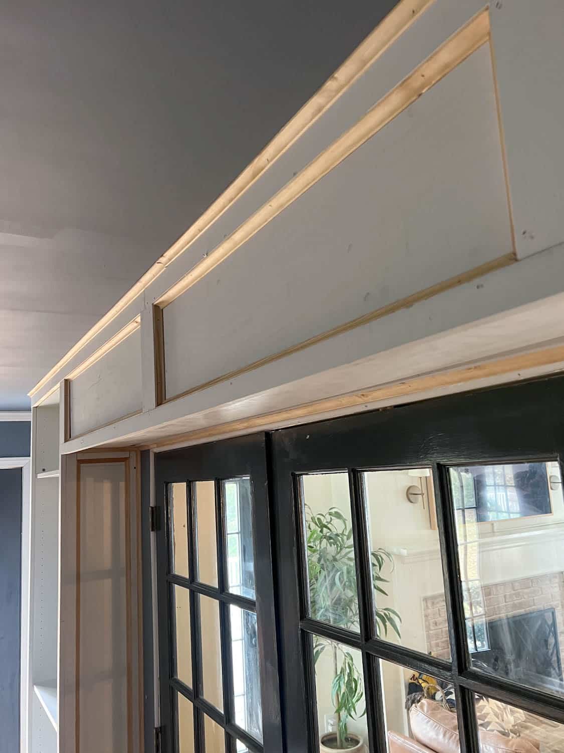 built in box between bookcases to hide projector screen