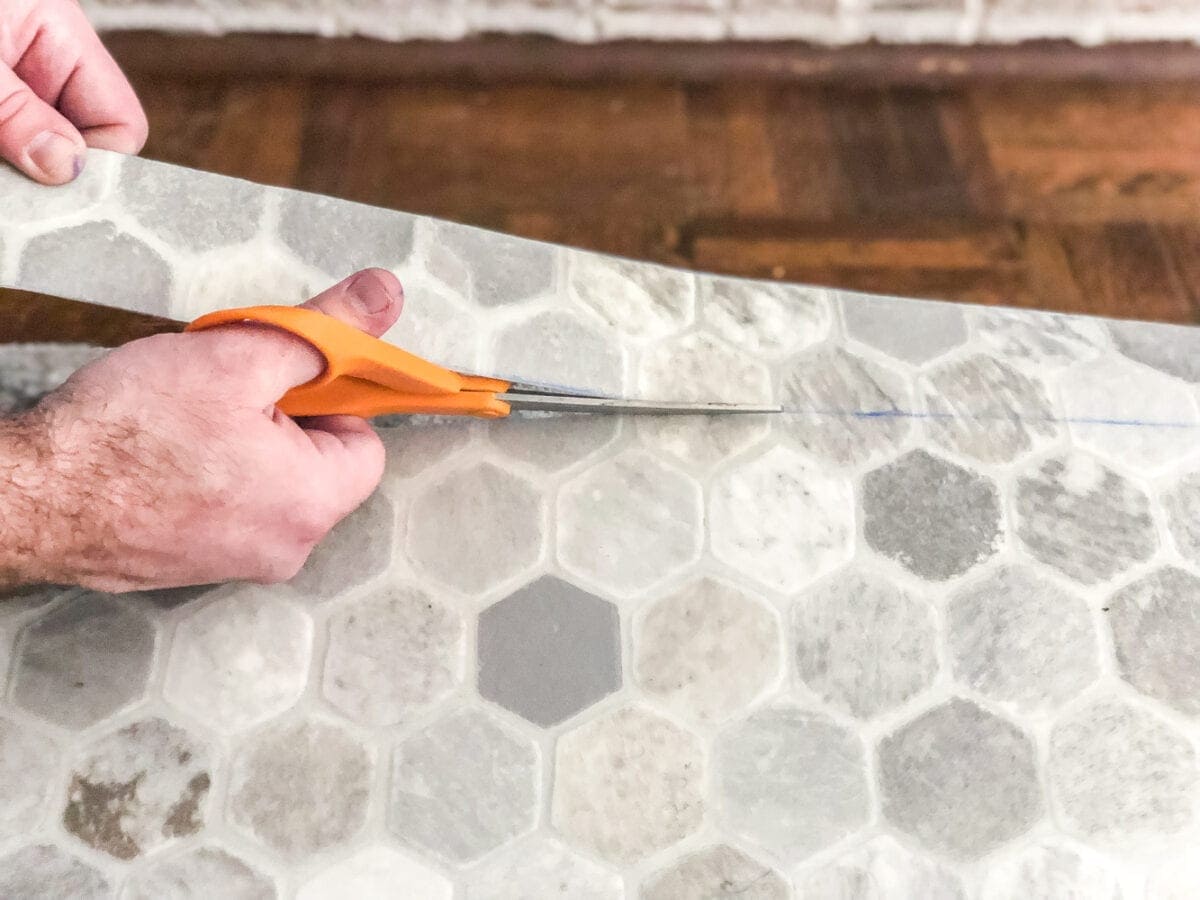 cutting sheet vinyl template with scissors for flooring installation