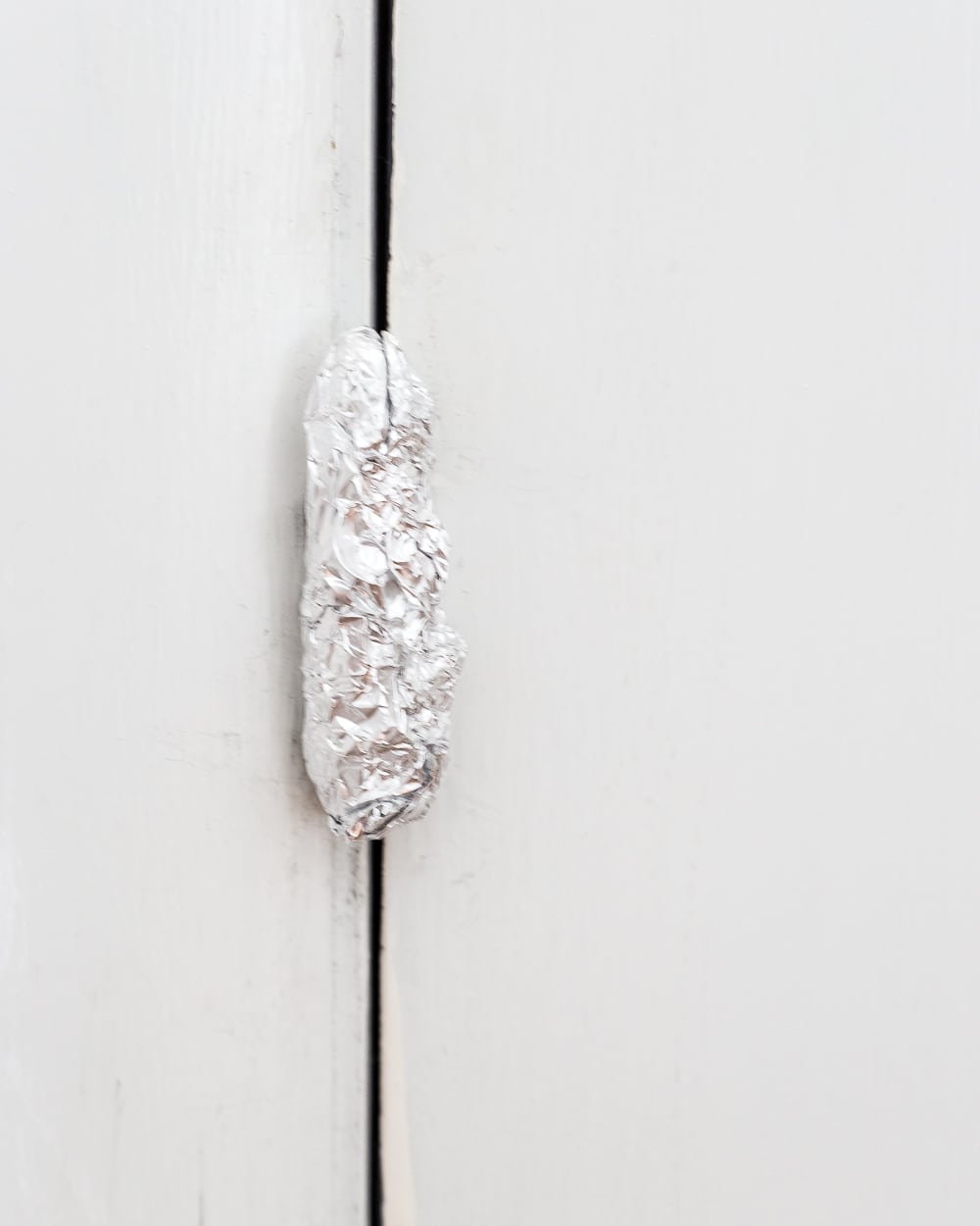 Tip: Use aluminum foil on hinges and doorknobs before painting doors