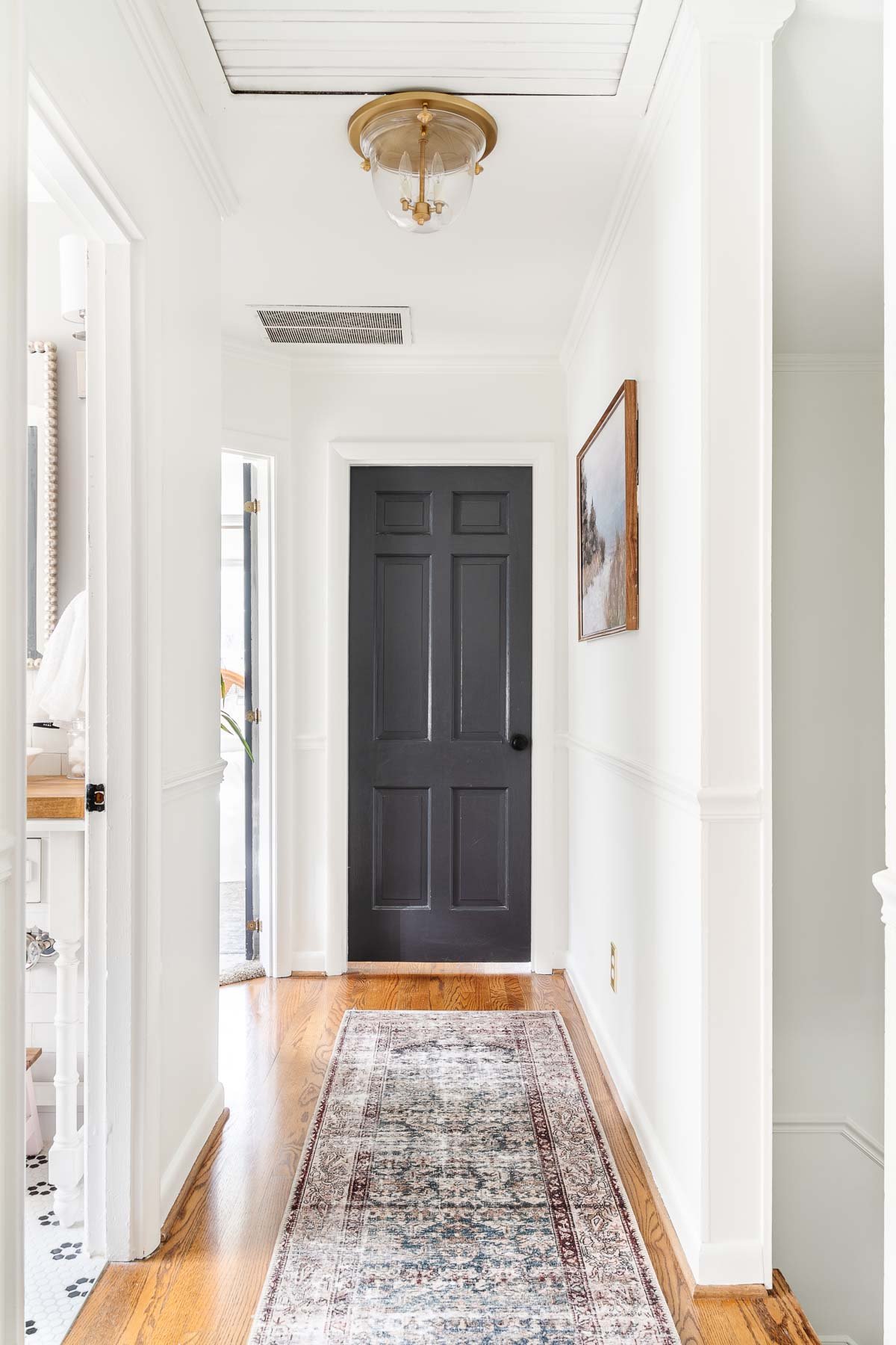 hallway with Benjamin Moore Wrought Iron on doors and Benjamin Moore Chantilly Lace on walls