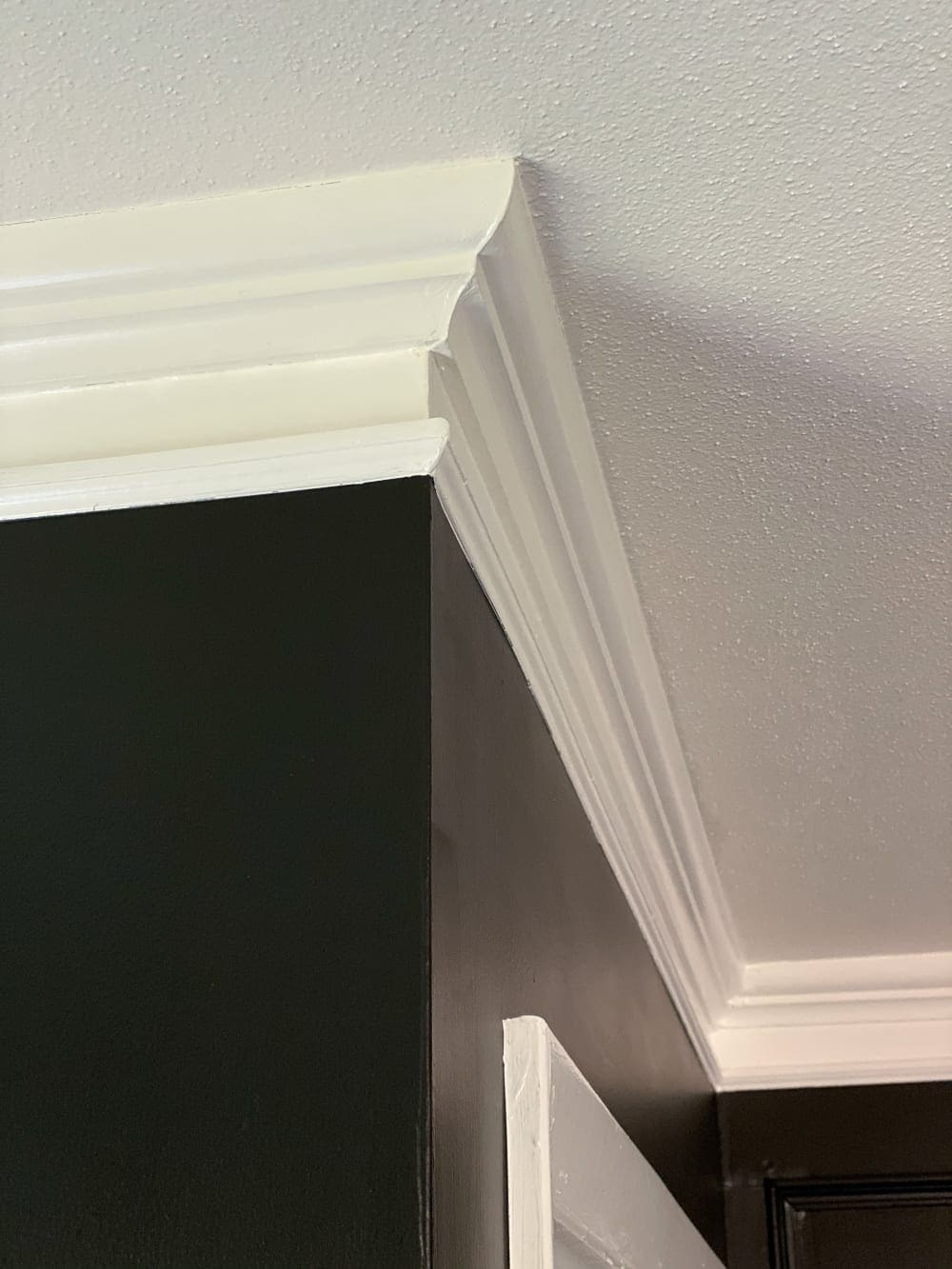 white crown molding and black painted walls