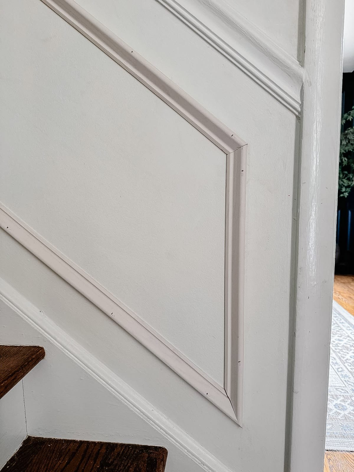 angled picture frame molding on stairs