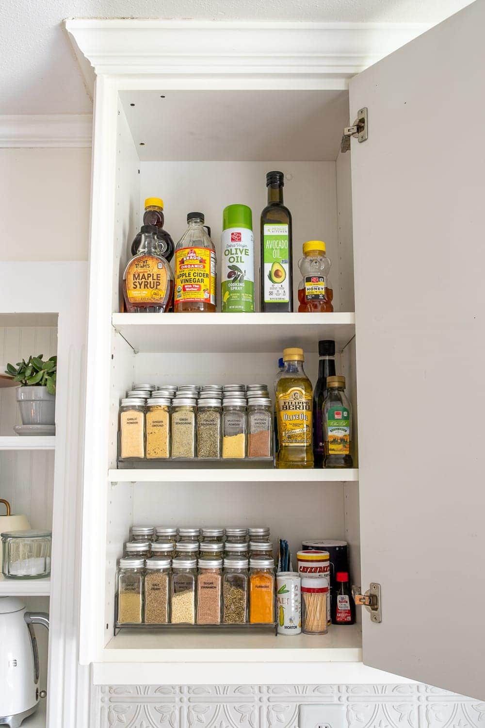 organized spice cabinet in a kitchen